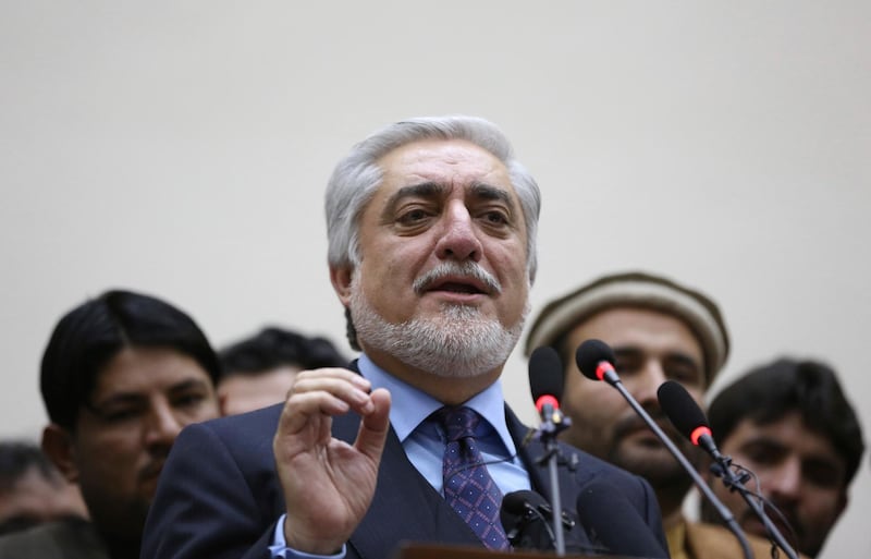 Afghan presidential candidate Abdullah Abdullah, center, addresses the media following a conference with his party members in Kabul, Afghanistan, Sunday, Jan. 26, 2020. (AP Photo/Rahmat Gul)