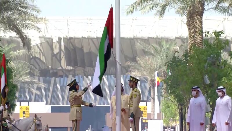 The UAE flag being raised at Al Wasl Plaza at the Expo 2020 Dubai site.