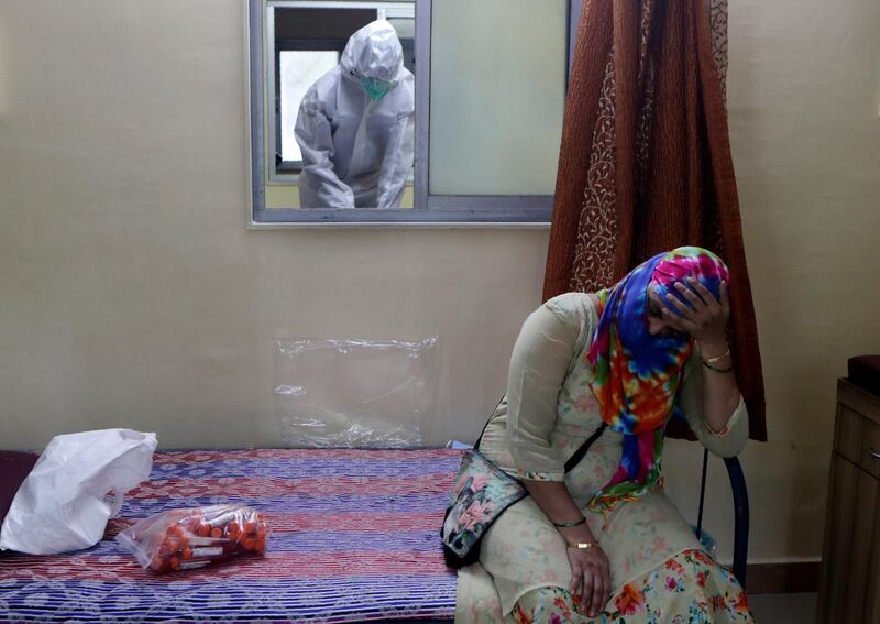 A woman waits to give a nasal swab sample at a medical camp in Mumbai, India. AP Photo