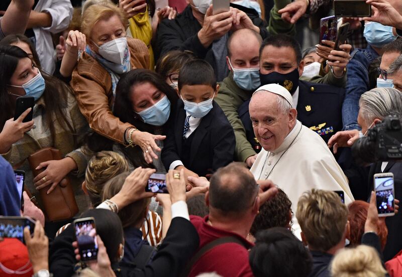 Pope Francis is greeted by worshippers at the end of the general audience in the Vatican. AFP
