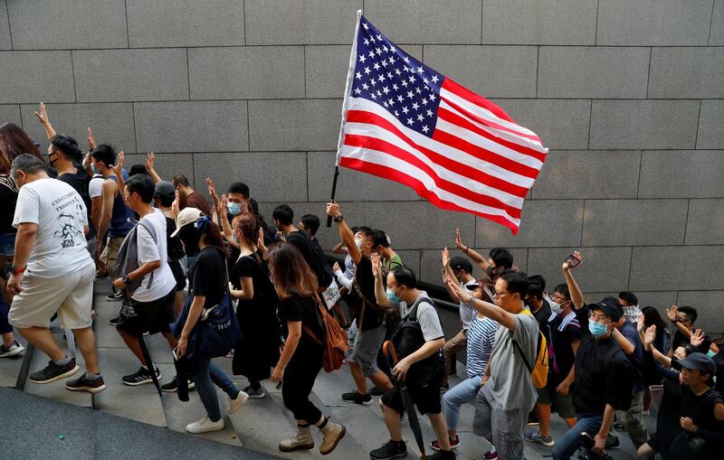 Protesters hold up five fingers and a U.S. flag during a rally to the U.S. Consulate General in Hong Kong, China September 8, 2019. REUTERS/Anushree Fadnavis