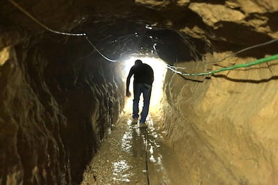 A Palestinian man walks from the Egyptian side of the border in a repaired bombed smuggling tunnel linking the Gaza Strip to Egypt. AFP