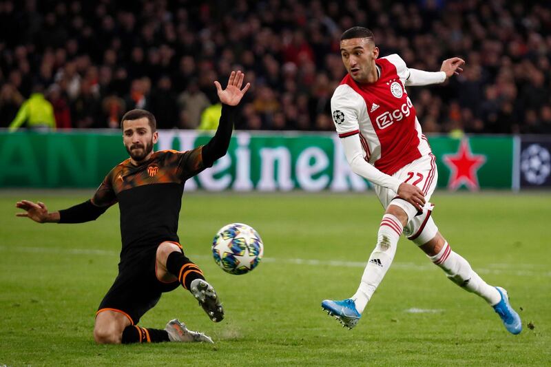 Ajax's Hakim Ziyech fail to score as Valencia's Jose Luis Gaya stretches to block the shot during the group H Champions League soccer match between Ajax and Valencia at the Johan Cruyff ArenA in Amsterdam, Netherlands, Tuesday, Dec. 10, 2019. (AP Photo/Peter Dejong)