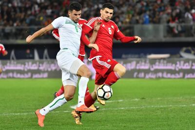 UAE's Mohanad Salem (R) fights for the ball against Iraq's Aymen Hussein during the 2017 Gulf Cup of Nations semi-final football match between Iraq and UAE at the Sheikh Jaber al-Ahmad Stadium in Kuwait City on January 2, 2018.  / AFP PHOTO / GIUSEPPE CACACE