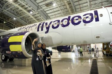 Female cabin crew pose in front of a flyadeal aircraft. AFP 