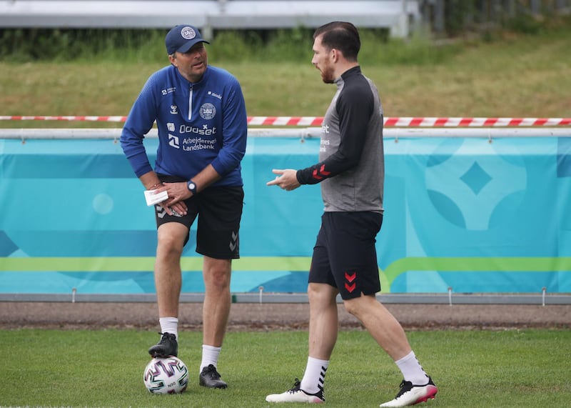 Denmark's Pierre-Emile Hojbjerg talks to coach Kasper Hjulmand during training. Reuters