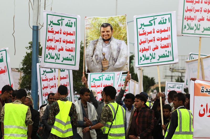 epa07764549 A supporter of the Houthi rebels holds up a banner depicting a portrait of the leader of the Houthi rebels, Abdul-Malik al-Houthi, during a rally protesting the Saudi-led military campaign on Yemen, outside Sana'a Airport in Sana'a, Yemen, 09 August 2019. According to reports, the Houthi rebels announced that Ibrahim al-Houthi, a brother of Houthi leader Abdul-Malik al-Houthi, has been assassinated at a house in the capital and accused unidentified people linked to the Saudi-led coalition of killing al-Houthi who was an influential military commander among the Houthi forces.  EPA/YAHYA ARHAB