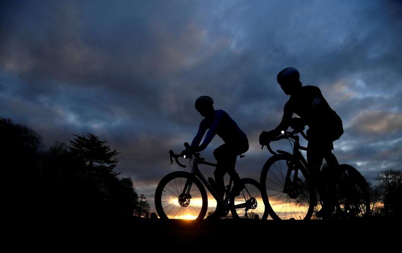 Cyclists take permitted exercise at sunrise in Richmond Park, London. Reuters