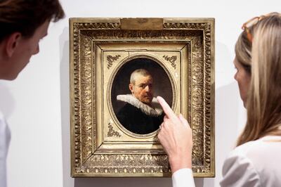 Manja Rottink, senior international specialist of Old Master paintings at Christie’s, with one of the two portraits. AFP