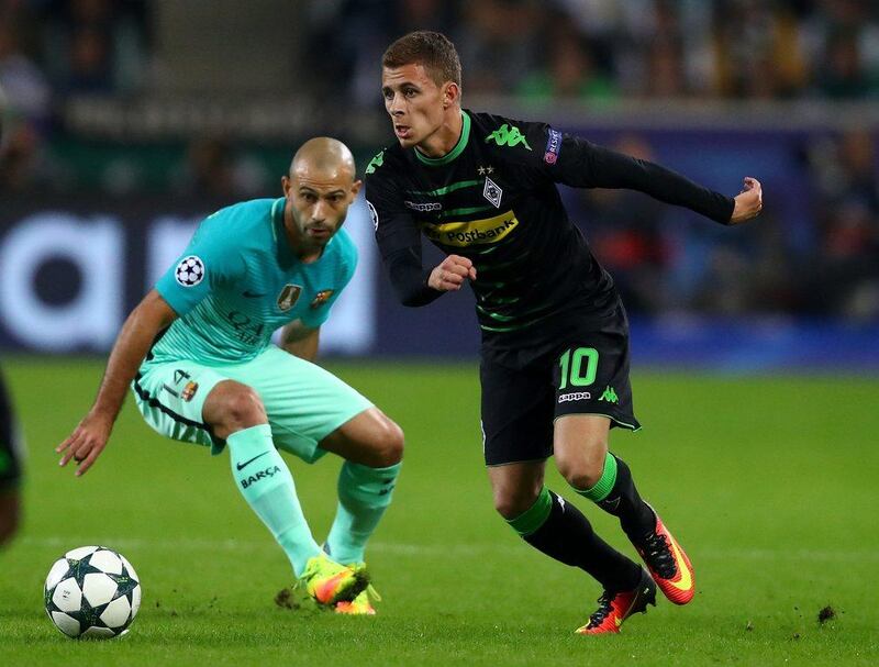 Thorgan Hazard of Borussia Monchengladbach runs with the ball under pressure from Javier Mascherano of Barcelona. Dean Mouhtaropoulos / Getty Images