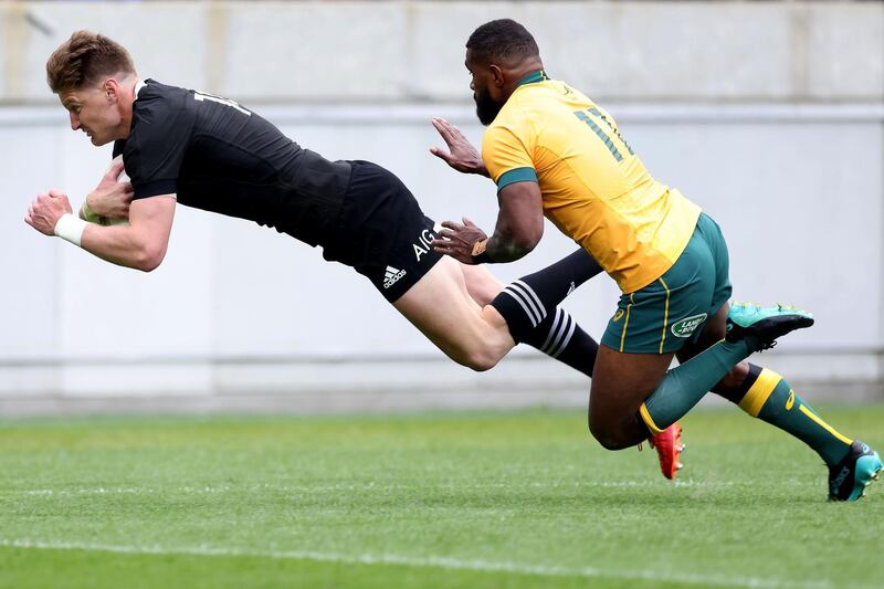 Australia's Marika Koroibete (R) tackles New Zealand's Jordie Barrett as he scores a try during the Bledisloe Cup rugby union match between New Zealand and Australia in Wellington. AFP