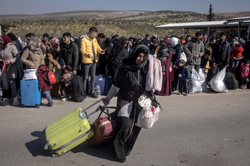A displaced Syrian woman walks towards Turkey's Cilvegozu border crossing to Bab Al Hawa in Syria on Thursday. Getty