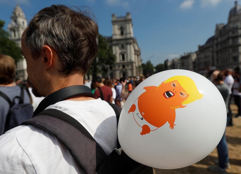 A balloon portraying U.S. President Donald Trump as a baby is attached to a man's rucksack. Reuters