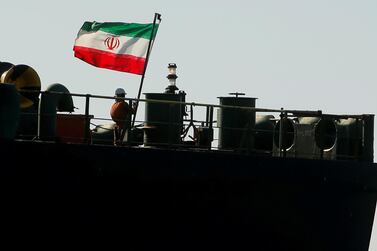 A crew member raises the Iranian flag on oil tanker Adrian Darya 1, previously named Grace 1. REUTERS/Jon Nazca