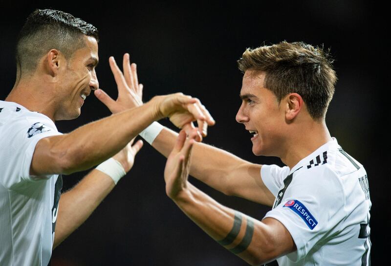 Paulo Dybala, right, is congratulated by Cristiano Ronaldo after giving Juventus the lead. Reuters