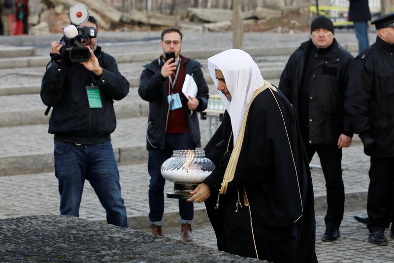 Mohammad Al-Issa places a candle during his visit to Auschwitz II Birkenau. Reuters