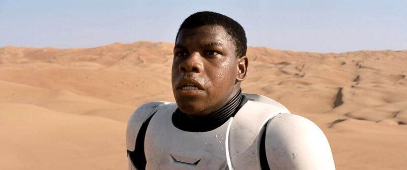 In this image released by Disney, a scene is shown from the upcoming film, "Star Wars: The Force Awakens," expected in theaters on Dec. 18, 2015.  John Boyega plays a force-sensitive storm trooper who defects from The Empire and winds up stranded on Tatooine and hunted as a deserter.(AP Photo/LucasFilm, Disney)