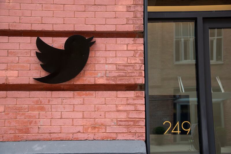 The Twitter icon is displayed outside the company's corporate office in New York. Elon Musk has threatened to back out of his deal to purchase the company. EPA