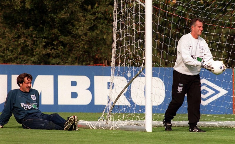 File photo dated 06-10-1997. England goalkeeper David Seaman, right, relaxes as coach Ray Clemence returns to the net during training at Bisham Abbey. PA Photo