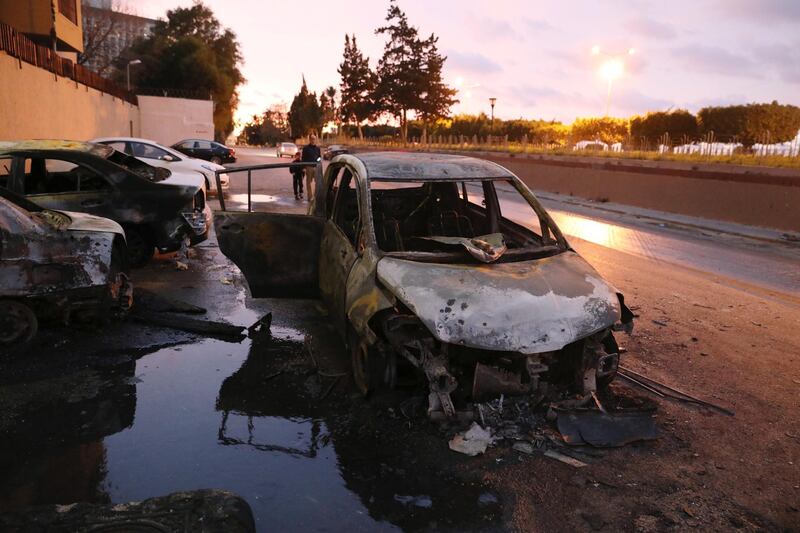 Burned cars are seen at the site of the headquarters of Libya's Foreign Ministry after suicide attackers hit in Tripoli, Libya December 25, 2018. REUTERS/Hani Amara