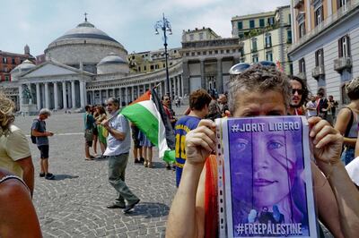 epa06917322 People take part in a solidarity demonstration with Italian street artist Jorit Agoch, who was arrested by the Israeli police on charges of having damaged and defaced a defense barrier in Bethlehem, in Naples, southern Italy, 29 July 2018. About 250 people participated in the protest holding flags of Palestine and shouting the slogan 'Free Jorit'. Jorit Agoch was arrested on 28 July after he painted a mural of 17-year-old Palestinian activist Ahed Tamimi on the separation wall between the West Bank and Israel. Ahed Tamimi, who was arrested last December after she was filmed slapping an Israeli soldier near Ramallah, in the occupied West Bank, was released from prison on 29 July 2018 after serving nearly eight-month in detention.  EPA/ANSA