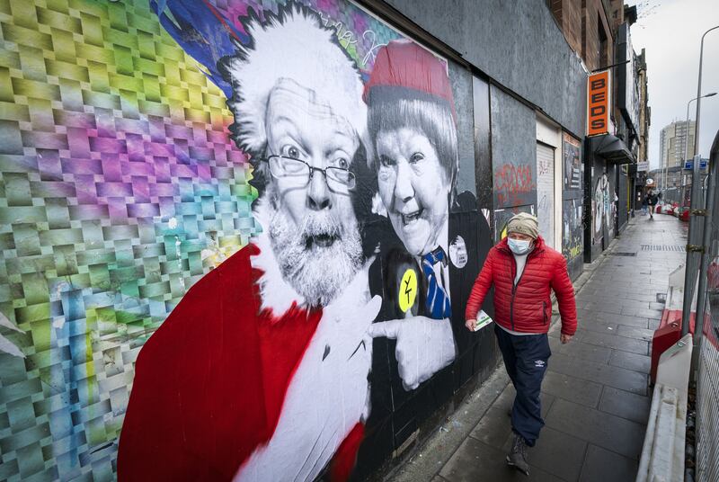 A poster featuring Father Christmas and Wee Jimmy Krankie, a popular character from children’s TV, on Leith Walk, Edinburgh. The Scottish government is considering whether to tighten Covid restrictions. PA