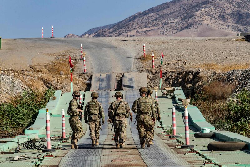 US soldiers patrol an area near Syria's northeastern Semalka border crossing with Iraq's Kurdish autonomous territory, on November 1, 2021. AFP