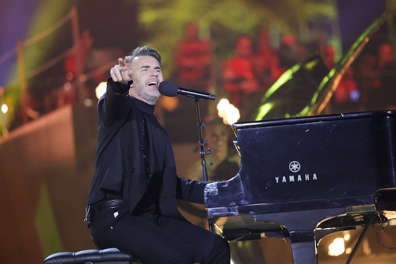Gary Barlow of Take That joins his bandmates on stage. Reuters