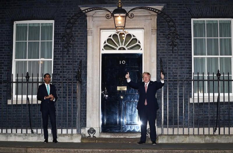 Britain's Prime Minister Boris Johnson and Chancellor of the Exchequer Rishi Sunak outside 10 Downing Street during the Clap For Our Carers campaign in support of the NHS, as the spread of the coronavirus disease (COVID-19) continues, London, Britain, March 26, 2020. REUTERS/Hannah McKay