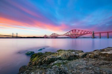 Adventure awaits in Scotland, where the Forth Bridge near Edinburgh catches the eye under a stunning pink and blue sky. Photo: Unsplash