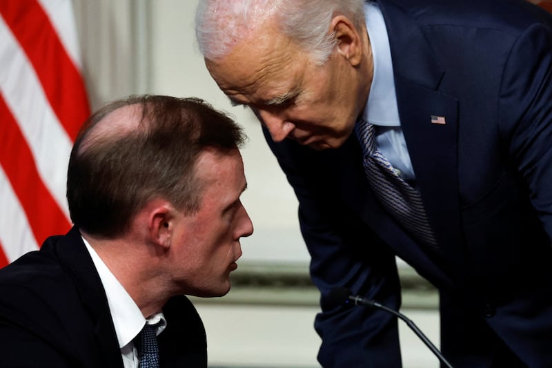 US President Joe Biden confers with National Security Adviser Jake Sullivan on Wednesday. Reuters