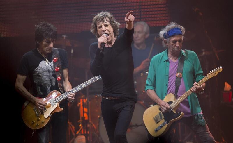 Mick Jagger, centre, Ronnie Wood, left, Charlie Watts, rear on drums and Keith Richards, right, of British band the Rolling Stones, perform on the Pyramid main stage at Glastonbury. AP