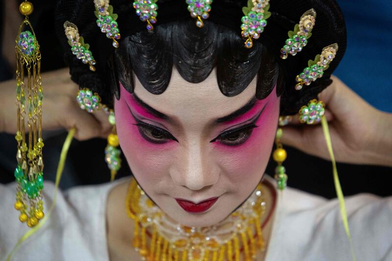 An actress prepares herself before performing in a Chinese Opera during the celebrations of God Tou Tei in Macau, China. AFP