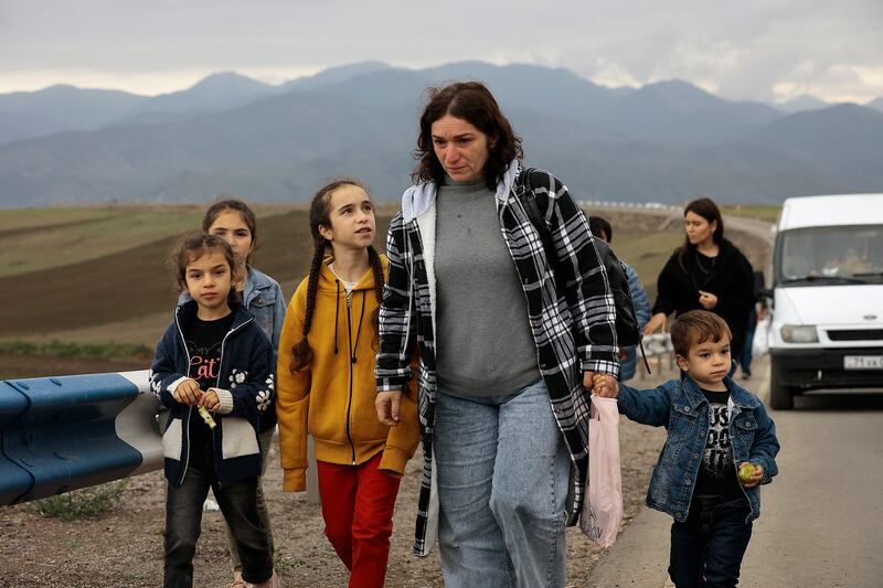 Ethnic Armenians fleeing Nagorno-Karabakh walk on a road to Kornidzor, in Armenia's Syunik region. AP