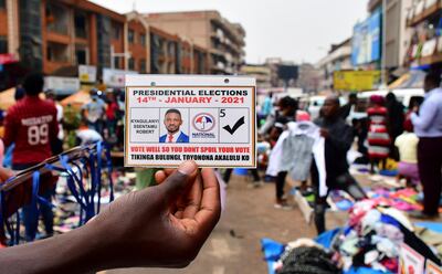 A vendor holds an electoral card of Ugandan opposition Presidential candidate Robert Kyagulanyi also known as Bobi Wine ahead of the presidential and parliamentary elections, in Kampala, Uganda January 12, 2021. REUTERS/Abubaker Lubowa