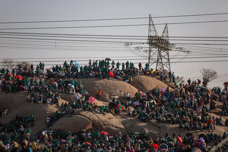 People gather on Wonderkop in Marikana, Rustenburg, where striking mineworkers were killed during the Marikana Massacre, to mark the event's seventh anniversary.  AFP