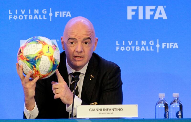 FIFA President Gianni Infantino holds a soccer ball as he speaks during a press conference after the FIFA Council Meeting, Friday, March 15, 2019, in Miami. The council approved working with Qatar to explore expanding the 2022 World Cup to 48 teams by adding at least one more country in the Persian Gulf to host matches. (AP Photo/Luis M. Alvarez)