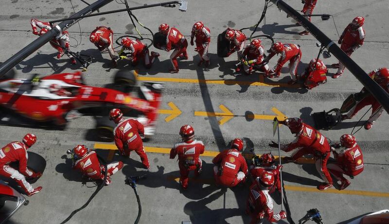 Ferrari driver Kimi Raikkonen of Finland steers his car into pit lane for a pit stop. Vincent Thian / AP Photo