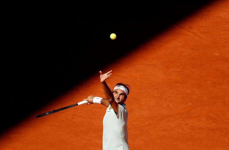 Roger Federer serves against Dominic Thiem. Reuters