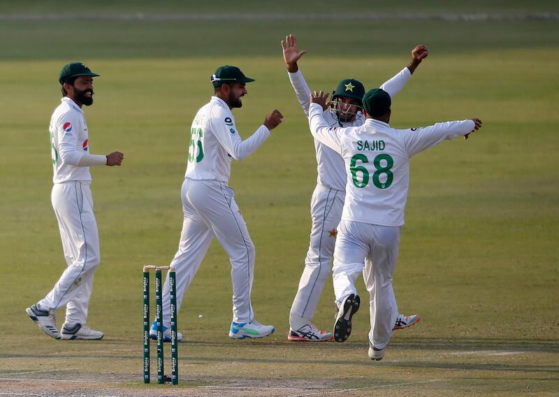 Pakistan's Abid Ali, second right, celebrates with teammates after taking the catch of South Africa's Rassie van der Dussen during the third day of the first Test at the National Stadium in Karachi on Thursday. AP
