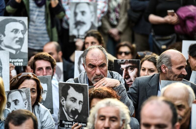 People hold portraits of Armenian intellectuals - who were detained and deported in 1915 - during a rally in Istanbul on April 24, 2018, held to commemorate the anniversary of the 1915 mass killing of Armenians in the Ottoman Empire. AFP