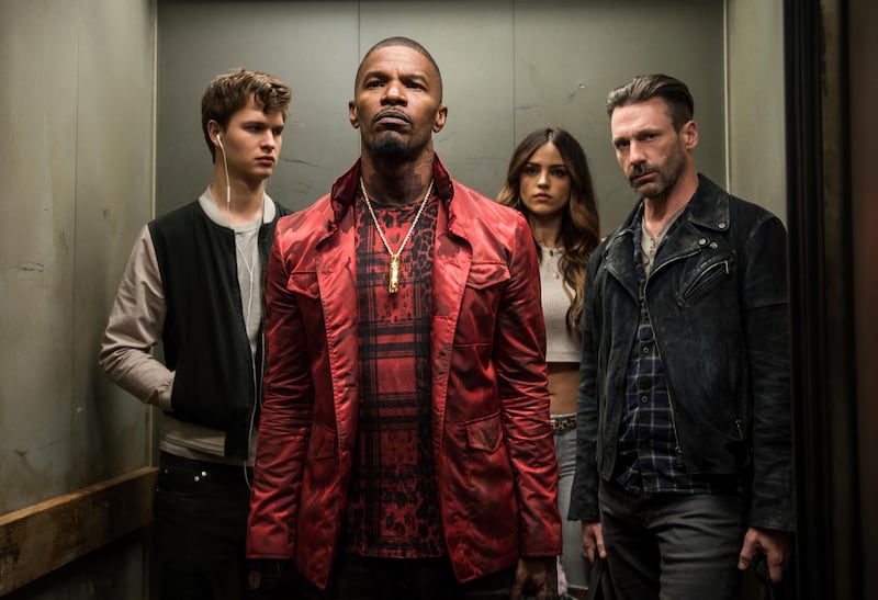 This image released by Sony/TriStar shows, from left, Ansel Elgort, Jamie Foxx, Eiza Gonzalez and Jon Hamm in a scene from the film, "Baby Driver." (Wilson Webb/Sony/TriStar via AP)
