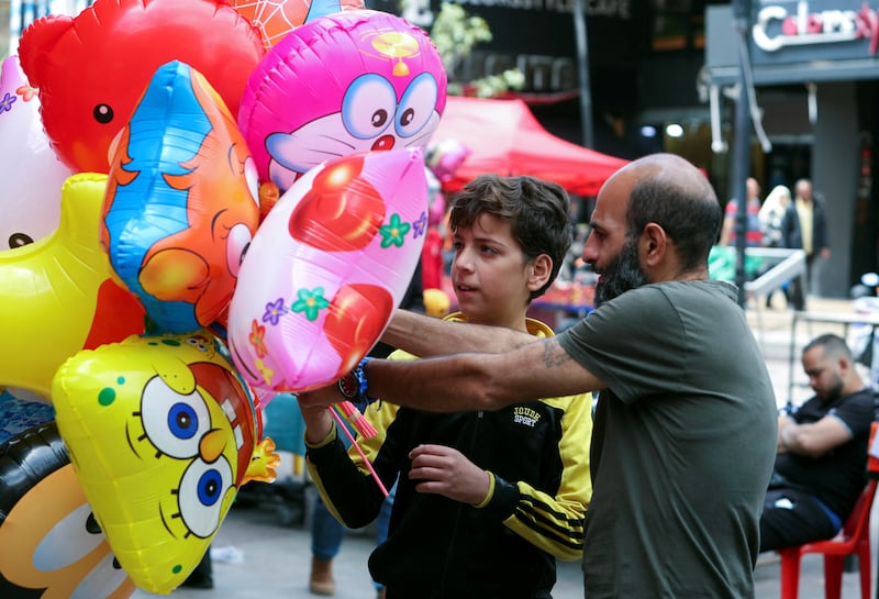 A street vendor sells balloons in Sidon. Reuters
