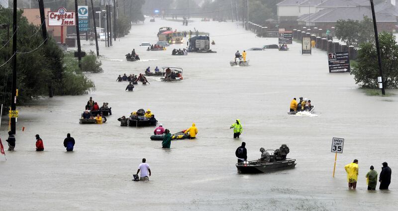 Rescue boats on flooded street in Houston. David J Phillip / AP Photo