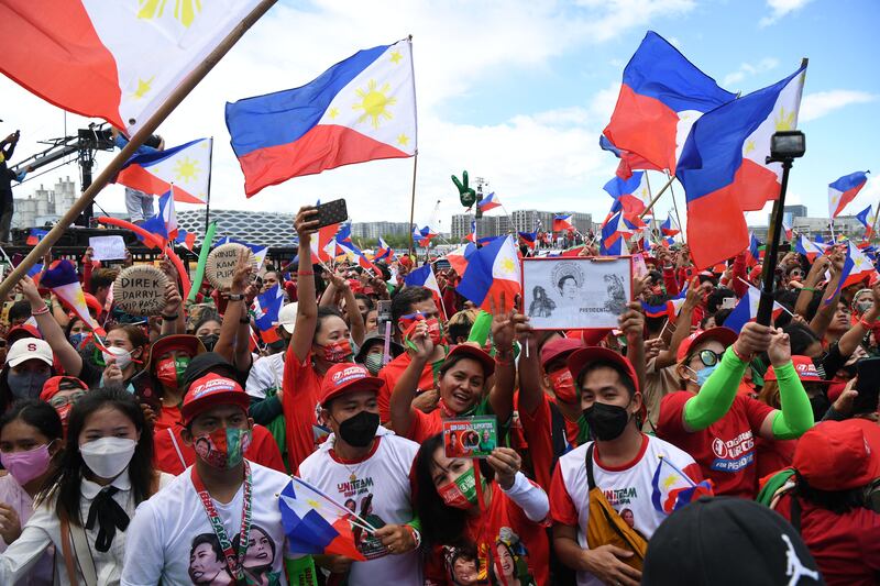 Supporters of Philippines presidential candidate Ferdinand Marcos Jr, son of the late dictator Ferdinand Marcos, flash the victory sign at a rally in Paranaque City, suburban Manila. AFP