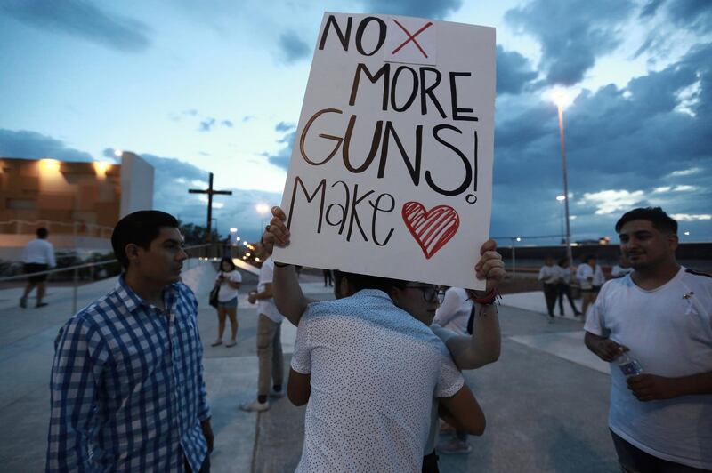 People gather in Juarez, Mexico, in a vigil for the 3 Mexican nationals who were killed in the El Paso shopping-complex shooting. AP Photo