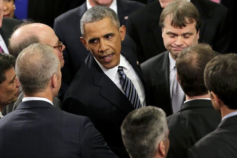 President Barack Obama greets guests after giving his State of the Union address before a joint session of Congress on Capitol Hill in Washington DC. J Scott Applewhite / AP Photo