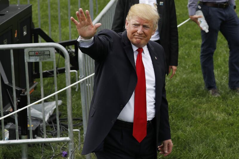 U.S. President Donald Trump waves while greeting guests at a picnic for military families in Washington, D.C., U.S., on Wednesday, July 4, 2018. Dozens of retired military and national security officers joined the NAACP and the American Medical Association in urging a federal appeals court to uphold a court order blocking Trump's ban on transgender people serving in the military. Photographer: Yuri Gripas/Bloomberg