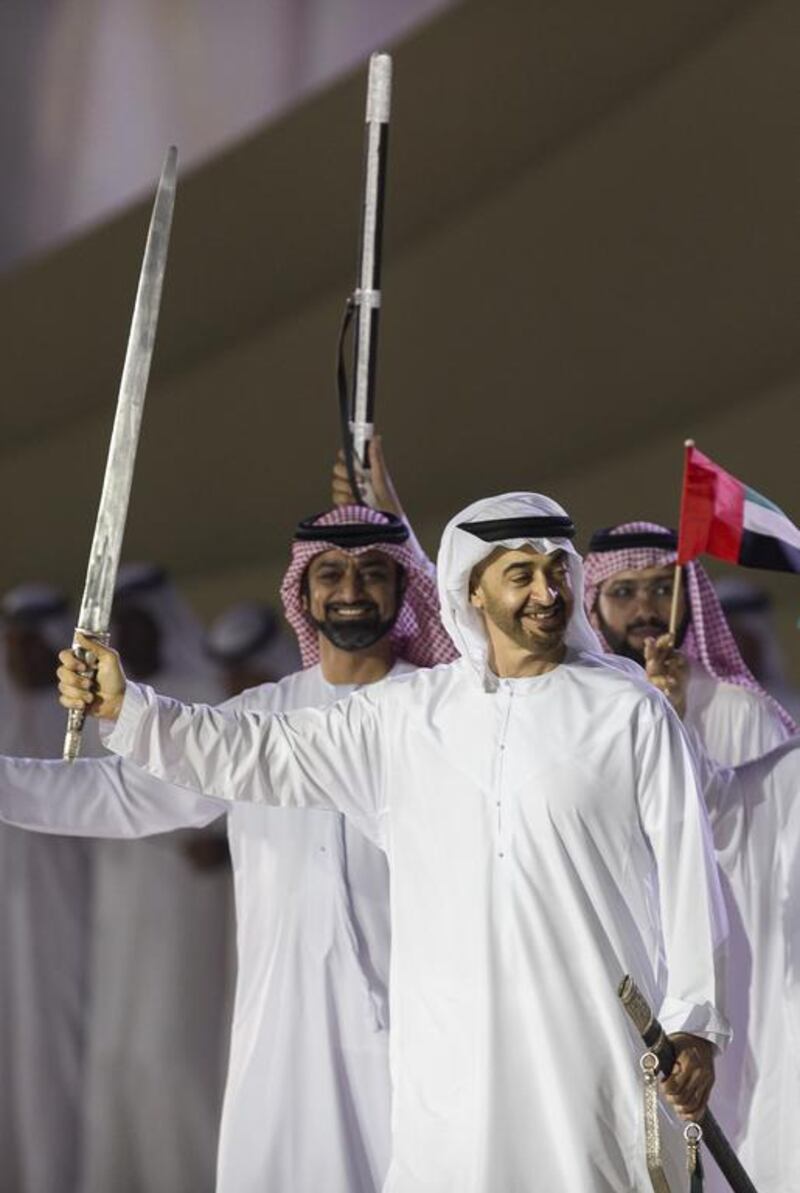 Sheikh Mohammed bin Zayed dances during the 45th UAE National Day celebrations held at Adnec. Seen with Sheikh Ammar bin Humaid, Crown Prince of Ajman (back L). Philip Cheung / Crown Prince Court — Abu Dhabi