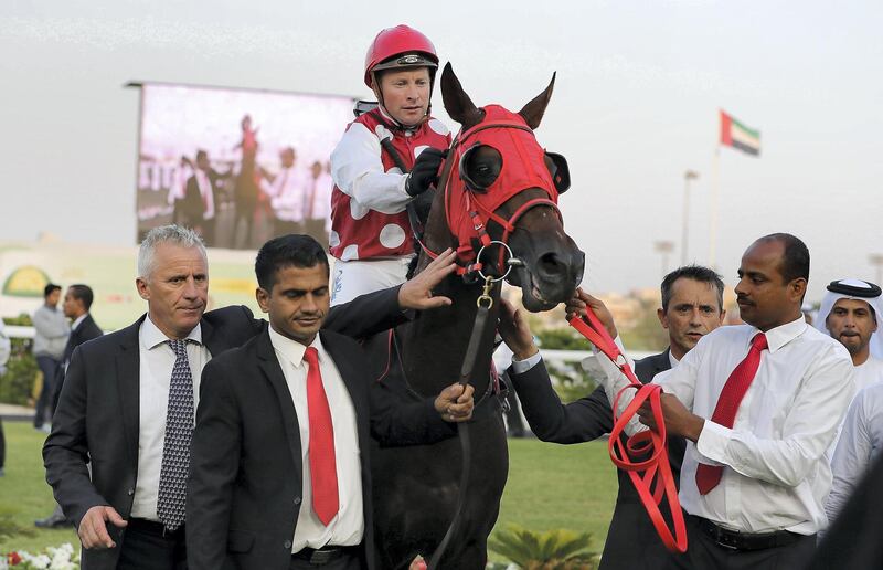 ABU DHABI , UNITED ARAB EMIRATES , DEC 10  – 2017 :-  Hawafez ( AE )    ridden by Tadhg O’Shea ( no 8 ) won the first horse race 1400 m held at Abu Dhabi Equestrian Club in Abu Dhabi. Also seen in the photo Eric Lemartinel ( Trainer left side ). (Pawan Singh / The National) Story by Amith